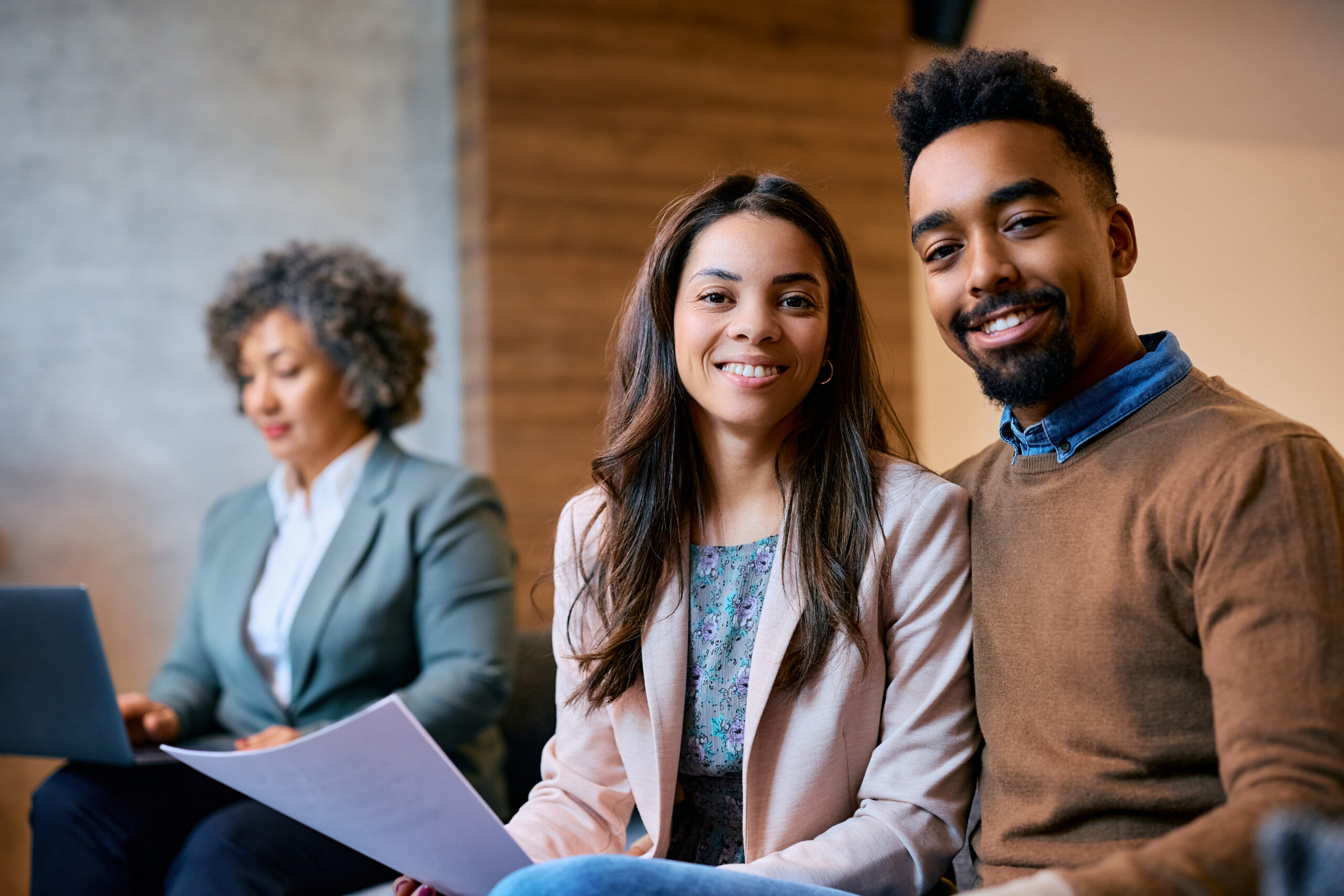 Happy black couple on a meeting with financial advisor looking at camera. Happy black couple on a meeting with financial advisor looking at camera.